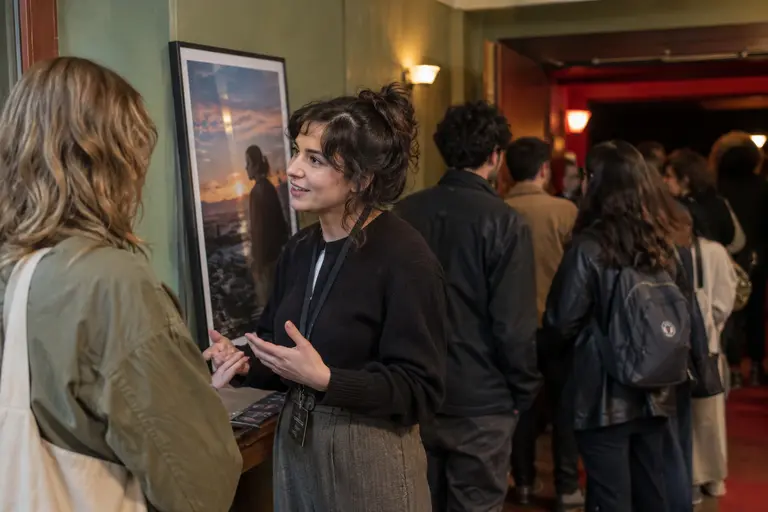 Small film venue lobby with viewers talking between screenings